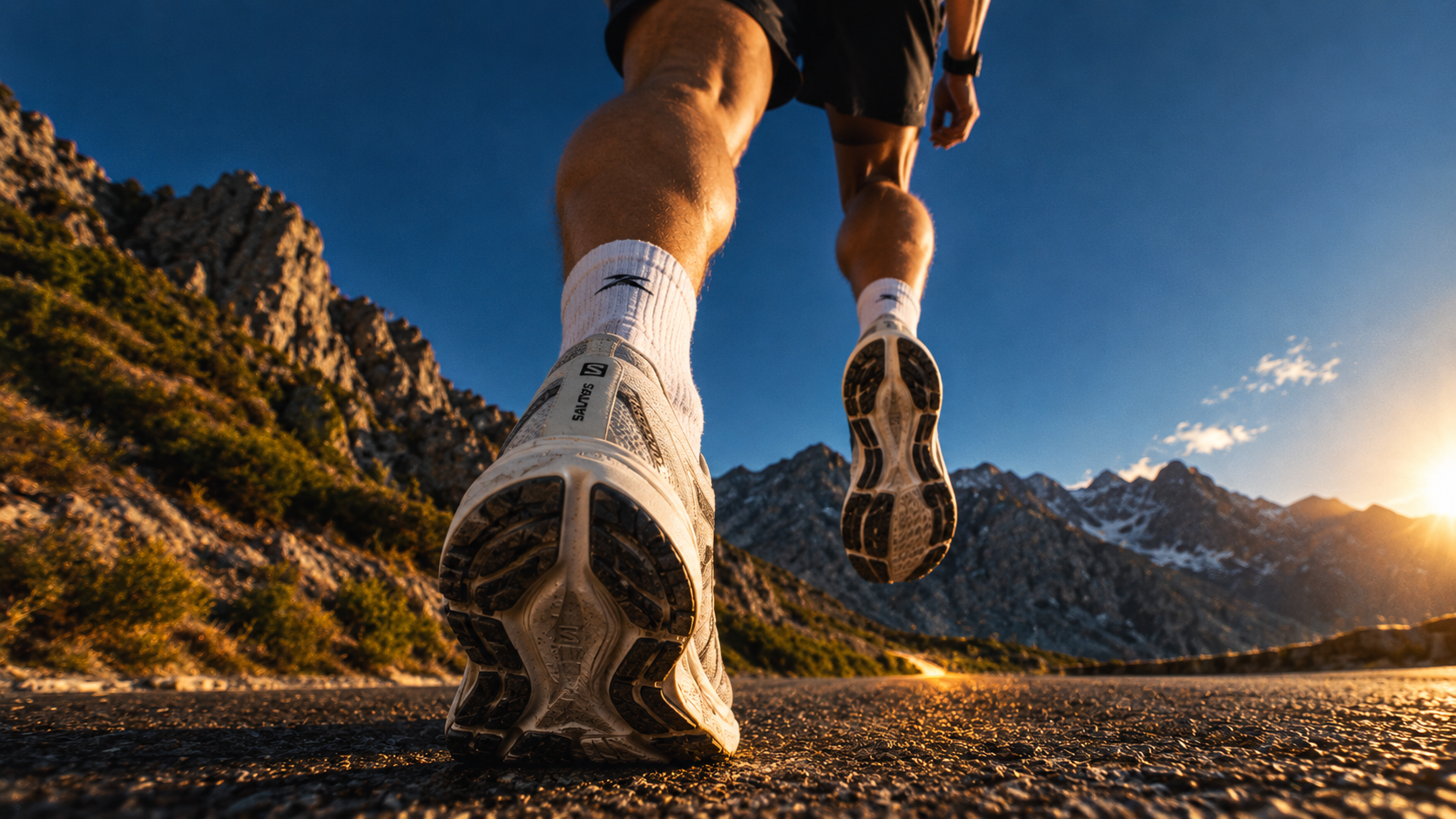 Runner on a mountain road at sunrise
